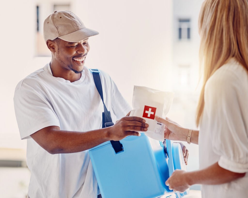 Healthcare, delivery and supply with a courier man making a delivery to a woman in her home. Medical, shipping and service with a male in a house to deliver a package to a female customer.